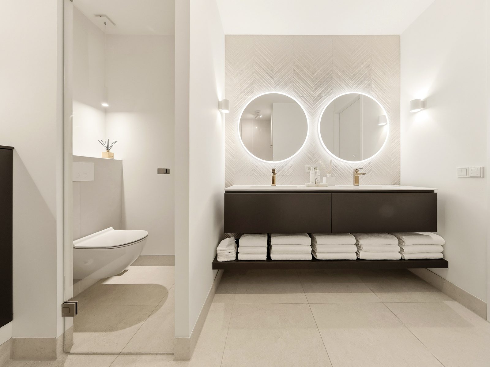 Moderne badkamer met dubbele wastafel en ronde spiegels
